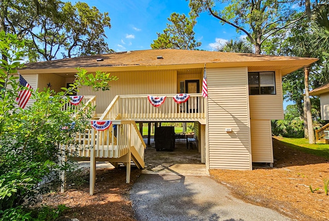 837 Club Cottage Rd, Edisto Island, SC 29438 - rear view of property featuring driveway and roof with shingles