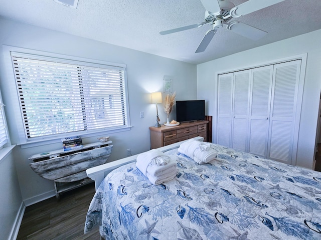 837 Club Cottage Rd, Edisto Island, SC 29438 - bedroom featuring dark wood-style flooring, a closet, a ceiling fan, and a textured ceiling