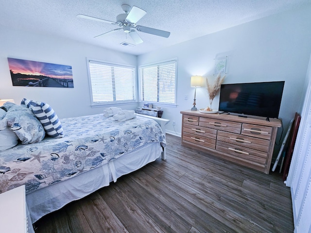 837 Club Cottage Rd, Edisto Island, SC 29438 - bedroom with dark wood-style flooring, a textured ceiling, and a ceiling fan