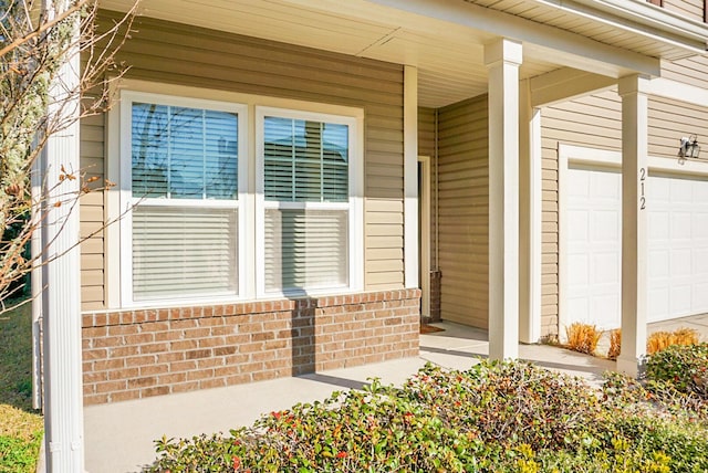 view of exterior entry with brick siding