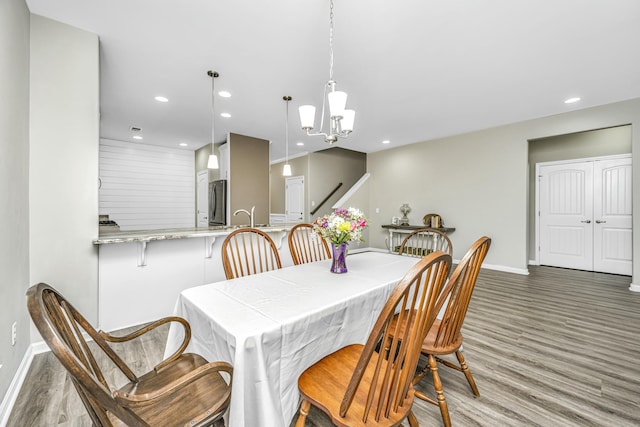 dining area featuring sink and dark wood-type flooring