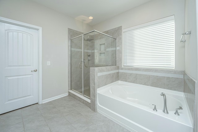 bathroom with tile patterned floors and independent shower and bath