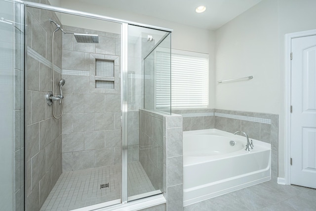 bathroom with tile patterned floors and separate shower and tub