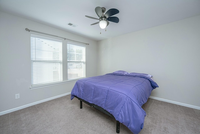 bedroom with ceiling fan and light colored carpet