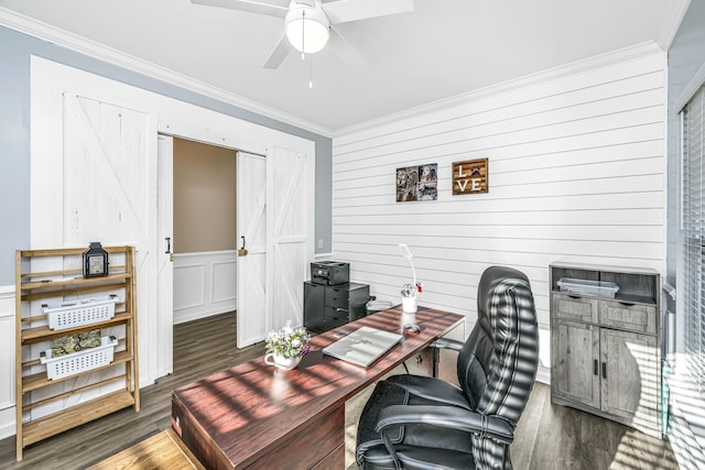 office with ceiling fan, a barn door, ornamental molding, and dark hardwood / wood-style flooring