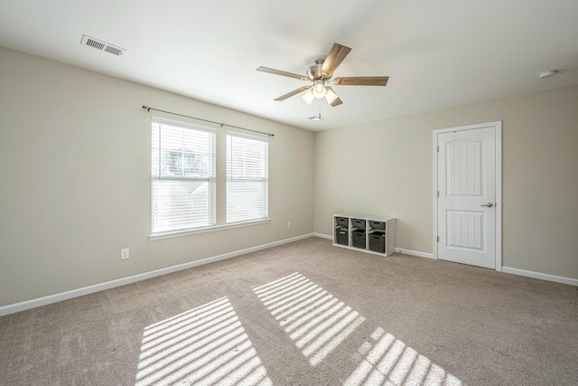 carpeted empty room featuring ceiling fan