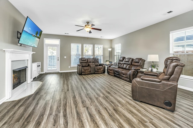 living room featuring ceiling fan and hardwood / wood-style floors