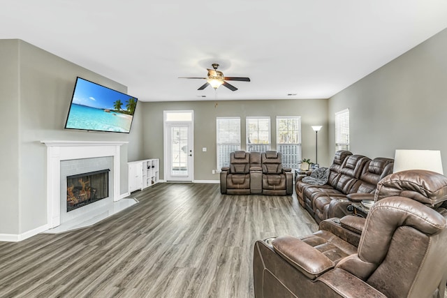 living room featuring wood-type flooring, plenty of natural light, and ceiling fan