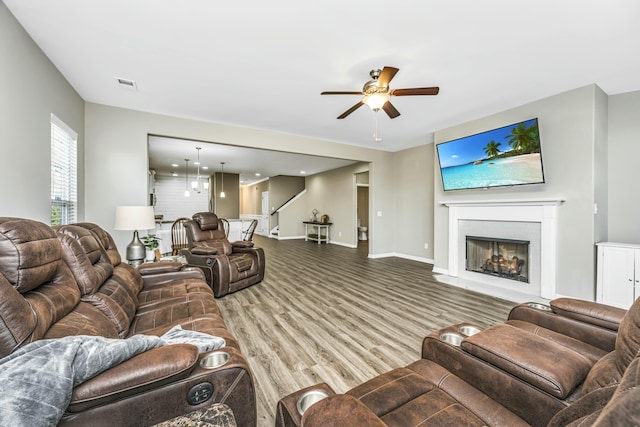 living room featuring hardwood / wood-style flooring and ceiling fan