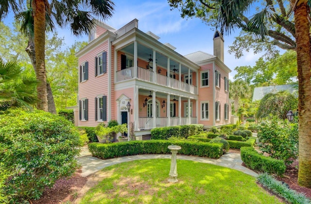62 Eastlake Rd, Mount Pleasant, SC 29464 - view of front of house featuring a balcony, ceiling fan, a chimney, and a porch
