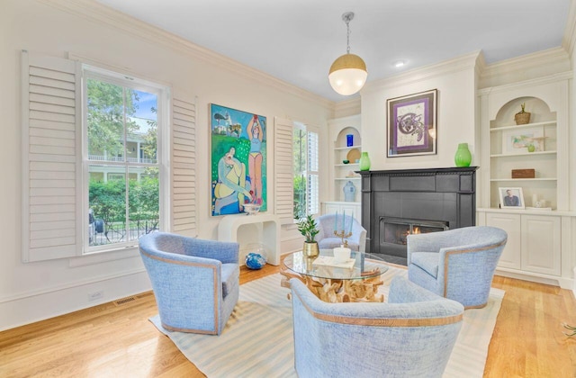 62 Eastlake Rd, Mount Pleasant, SC 29464 - living room with healthy amount of natural light, built in features, light wood finished floors, and crown molding