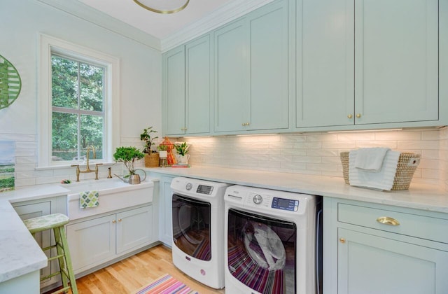 62 Eastlake Rd, Mount Pleasant, SC 29464 - laundry area with cabinet space, separate washer and dryer, light wood-style floors, and crown molding