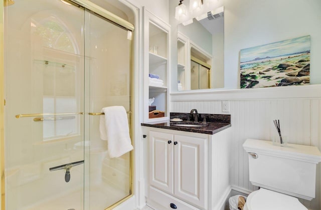 62 Eastlake Rd, Mount Pleasant, SC 29464 - bathroom with toilet, a stall shower, wainscoting, vanity, and a decorative wall