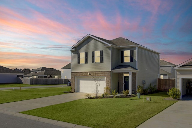 traditional-style home featuring fence, driveway, an attached garage, a front lawn, and brick siding