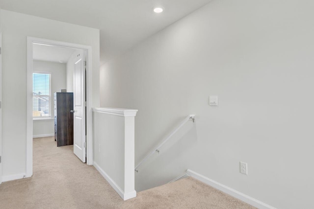 corridor with recessed lighting, baseboards, an upstairs landing, and carpet floors