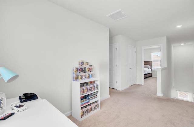 carpeted office with baseboards and visible vents