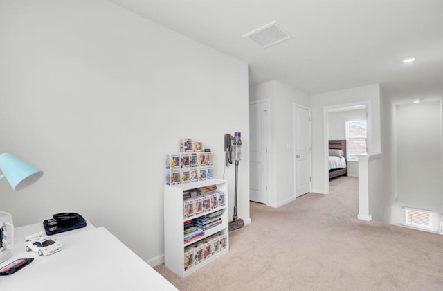 carpeted home office featuring visible vents and baseboards