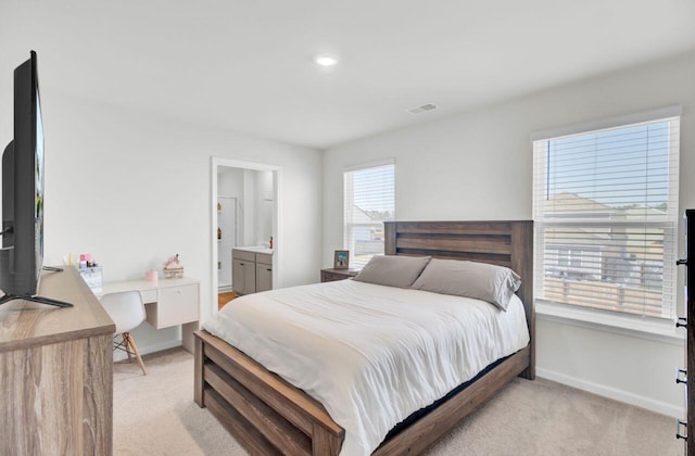 bedroom with light colored carpet and baseboards