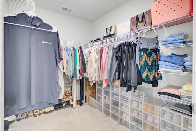 walk in closet with visible vents and carpet floors