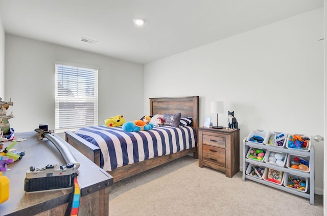 carpeted bedroom featuring visible vents