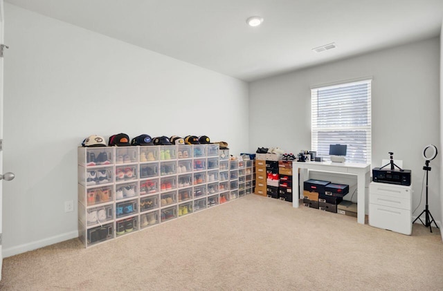 carpeted office featuring visible vents and baseboards