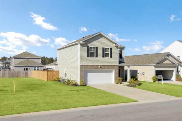 traditional-style home featuring a front yard, an attached garage, fence, and driveway