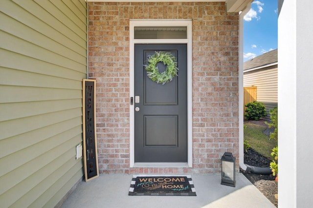 property entrance featuring brick siding