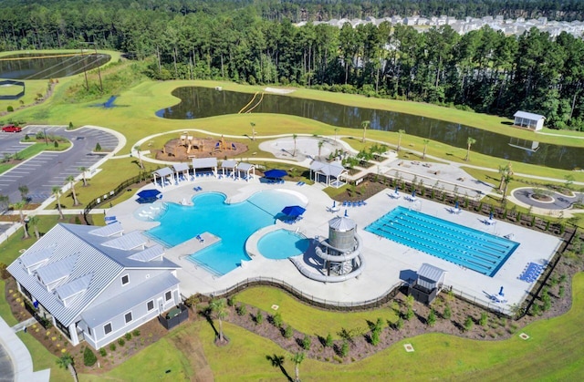 birds eye view of property featuring a water view, a wooded view, and golf course view