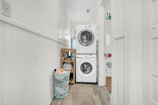 laundry area with stacked washer / dryer and laundry area