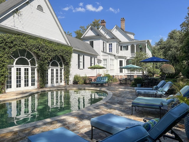 rear view of property featuring a patio area and french doors