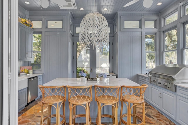 interior space featuring ceiling fan, wood walls, and wooden ceiling