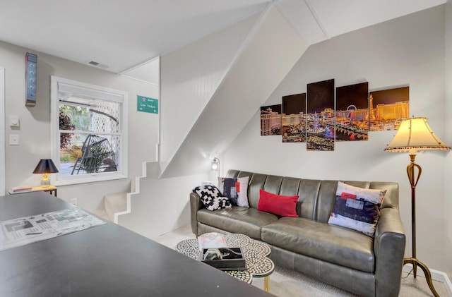 living room with carpet floors and vaulted ceiling