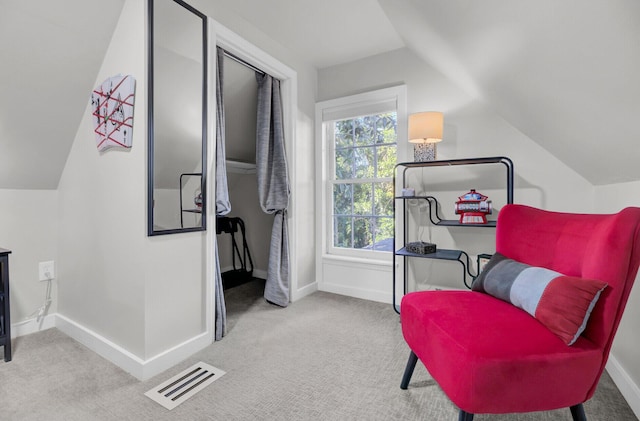 sitting room with light colored carpet and vaulted ceiling