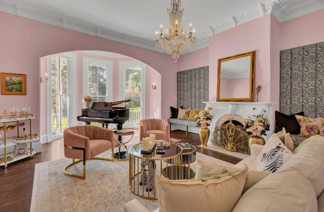 living room featuring a chandelier, dark hardwood / wood-style floors, and crown molding