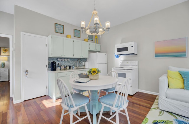 kitchen with white cabinetry, dark hardwood / wood-style floors, a notable chandelier, decorative light fixtures, and white appliances