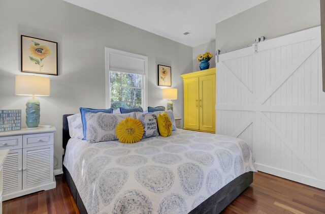 bedroom with dark hardwood / wood-style floors