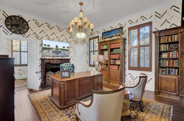 office space with crown molding, dark hardwood / wood-style flooring, and a chandelier