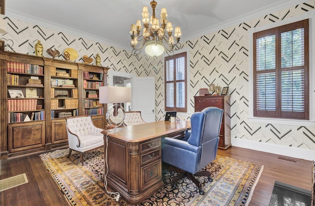 office space featuring dark hardwood / wood-style flooring, an inviting chandelier, and ornamental molding