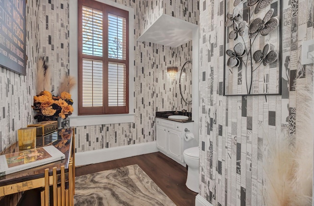 bathroom featuring wood-type flooring, vanity, and toilet