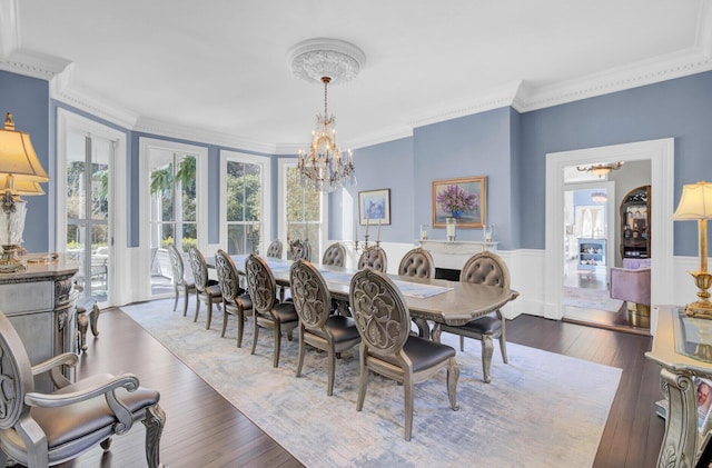 dining room with ornamental molding, dark wood-type flooring, and a notable chandelier