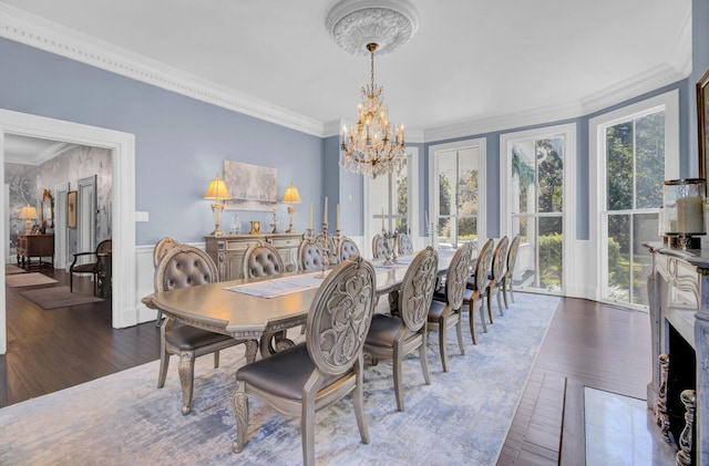 dining area featuring a healthy amount of sunlight, dark hardwood / wood-style flooring, and crown molding