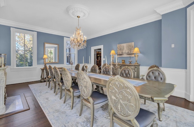 dining space with dark hardwood / wood-style floors and crown molding