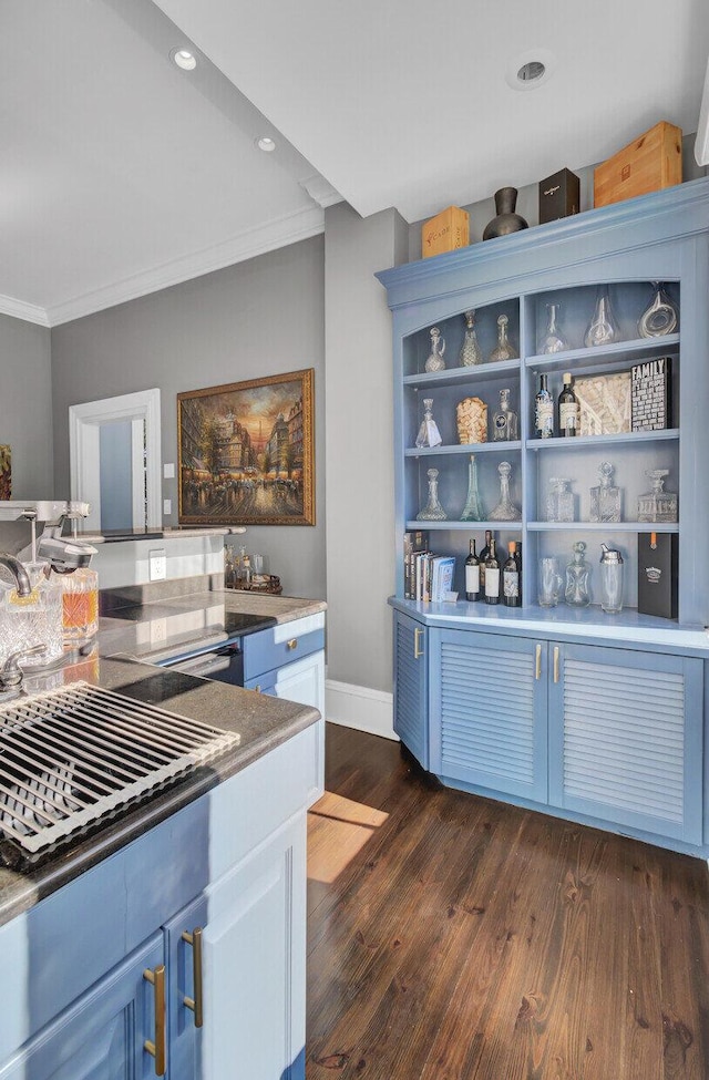 kitchen with dark hardwood / wood-style flooring, ornamental molding, and blue cabinets