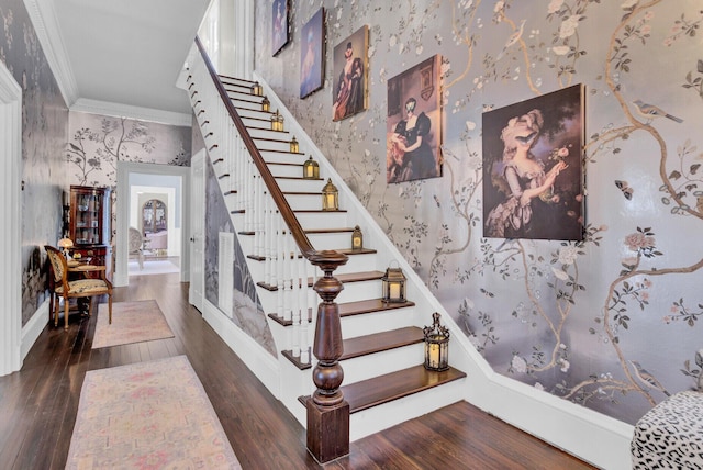 staircase featuring hardwood / wood-style flooring and crown molding