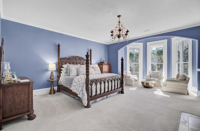 carpeted bedroom with a chandelier and ornamental molding