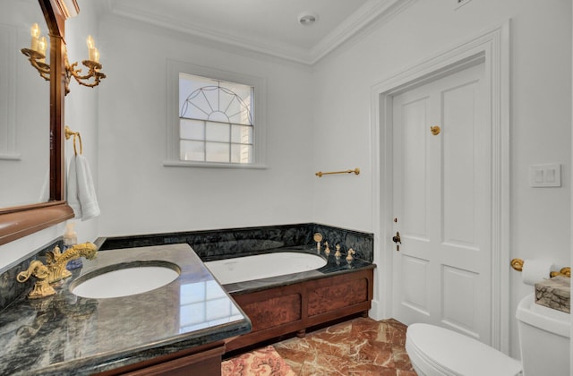 bathroom with a bathing tub, toilet, ornamental molding, and sink