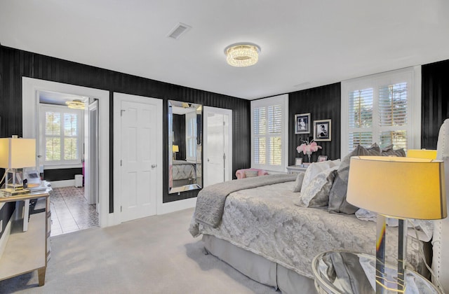 bedroom featuring carpet flooring and multiple windows