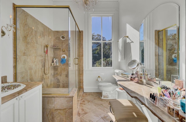 bathroom featuring vanity, toilet, walk in shower, and a chandelier