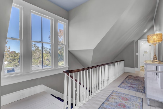 staircase with tile patterned flooring and vaulted ceiling