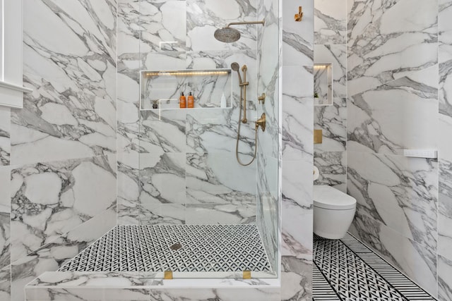 bathroom featuring stone wall and a marble finish shower